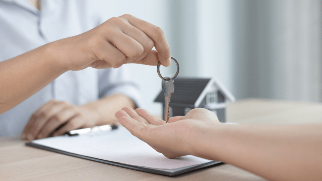 person giving house keys to another person